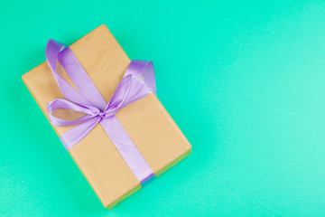 Decorated gift box on a green background, flat lay top view