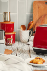 Kitchen shelf with red utensils and dishware
