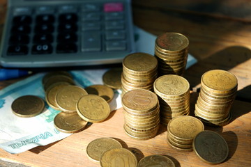 Money, coins, calculator on the table. Concept calculation of the family budget.
