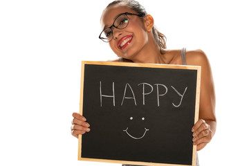 Happy dark skinned woman holding blackboard on white background