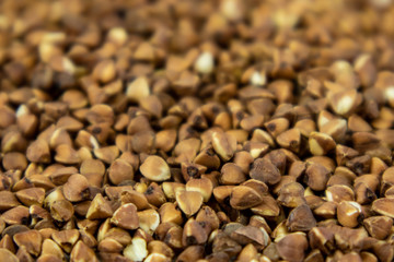 Close up background of raw roasted buckwheat