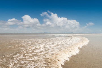 qiantang river tide against a blue sky