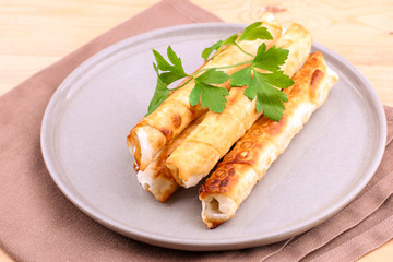 Traditional Turkish Pastries sigara borek - Deep Fried pies with cottage cheese and parsley.