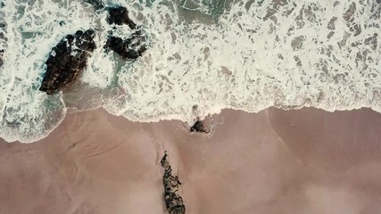 Above vertical view of blue ocean waves and yellow sandy beach - summer holiday vacation concept - travel and scenic place - energy nature outdoors with nobody there