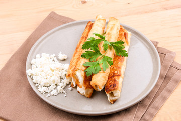 Traditional Turkish Pastries sigara borek - Deep Fried pies with cottage cheese and parsley.