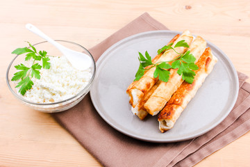 Traditional Turkish Pastries sigara borek - Deep Fried pies with cottage cheese and parsley.