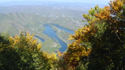 Naklejka na ściany i meble River in a gorge from mountain top