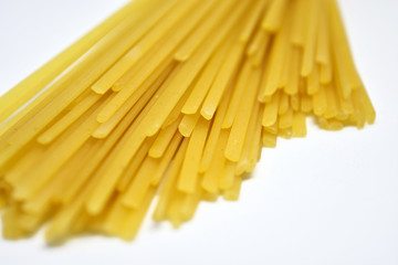 Raw Italian spaghetti pasta on white background.