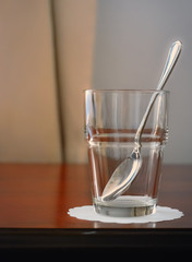 Teaspoon and glass