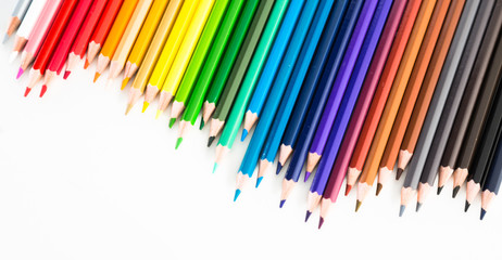 colored pencils lying in irregular row