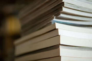 tall stack of paperback books - obrazy, fototapety, plakaty