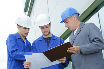 team of glass cleaners studying the building print