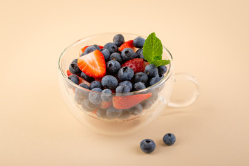 Fresh berry mix in tea cup, healthy food