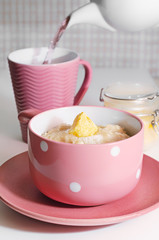 Delicious oatmeal for Breakfast, with sugar and melted butter.