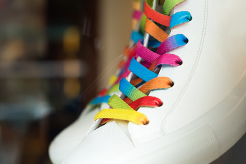 Closeup of a sneaker with colored shoelaces