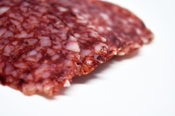 Salami sausage slices isolated on white background.