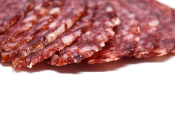 Salami sausage slices isolated on white background.