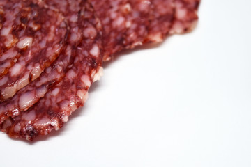 Salami sausage slices isolated on white background.