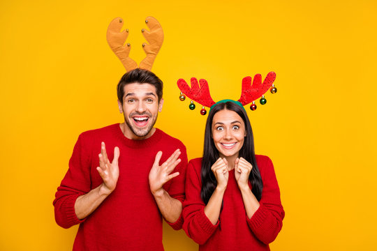 Portrait of impressed spouses scream wow omg wait for sales discount wear red sweater isolated over yellow background