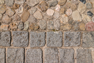 Cobblestone and pebble paving adjoin in the old town of Salzburg, Austria