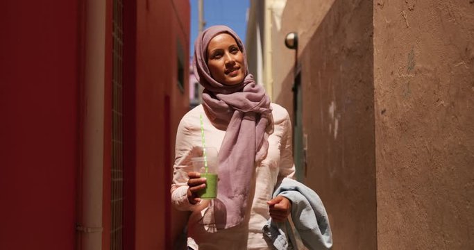 Young woman wearing hijab out and about in the city