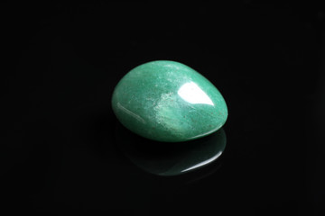 Beautiful green aventurine gemstone on black background