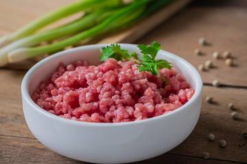 Raw minced pork in white bowl