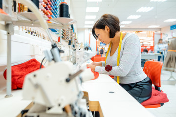 Seamstress working in her studio sewing clothes