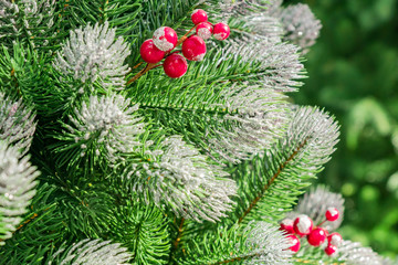 Christmas and New Year holidays background. Christmas tree decorated false snow  and garlands. Glittering and sparkling. Celebration concept
