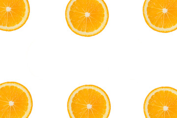 Colorful fruit pattern of fresh orange or lemon slices on on the edges of white isolated background. Top view. Copy space.