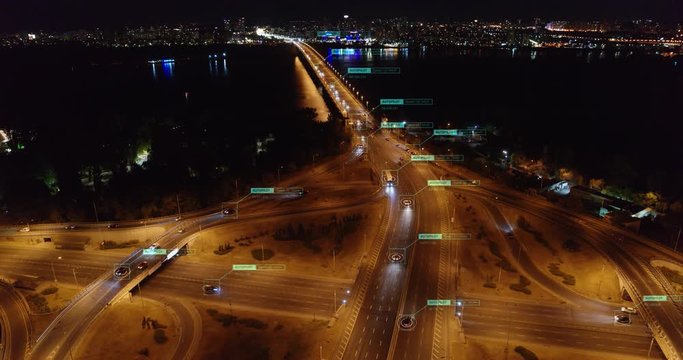 Self autonomous unmanned Cars driving on night crossroads Aerial view. Vehicles connected to Future transportation network. Internet of things and Artificial intelligence concept.