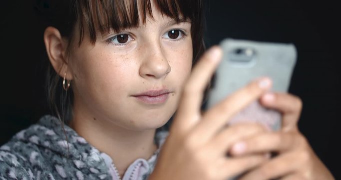 Teenager girl is using smartphone for browsing social network for chatting
