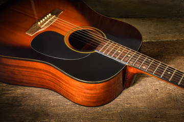 Acoustic guitar on old wood background