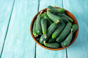 cucumbers in a bowl on wooden surface