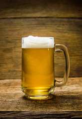 Glass beer on wooden background