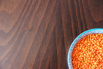 orange dry small oriental lentil groats in a ceramic white plate