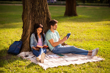 Her she his he nice attractive smart clever intellectual inspired best friends buddy fellow spending weekend free time on fresh open air sitting under tree on veil cover outside