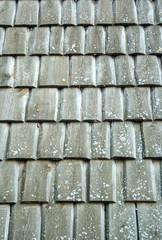wooden handmade aged and weathered tiles on roof texture background. Wooden rough pattern vertical