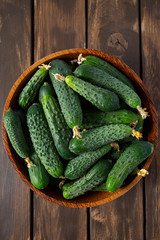 cucumbers in a bowl on wooden surface