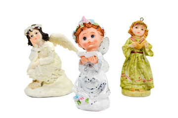 Three clay figurines Christmas angel for holiday on isolated background