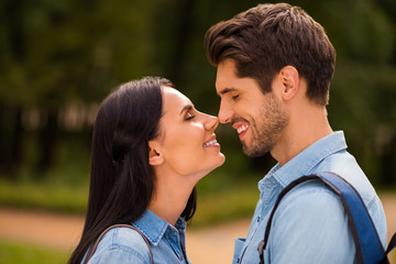 Profile photo of amazing pair going to kiss contacting noses closing eyes wear denim outfit