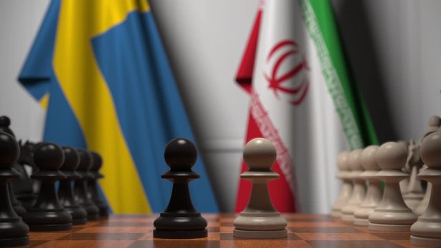 Flags of Sweden and Iran behind pawns on the chessboard. Chess game or political rivalry related 3D animation