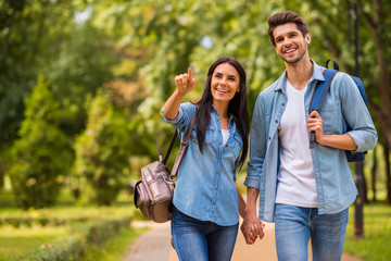 Photo of charming pair walking green sunny day observing sightseeing wear denim outfit