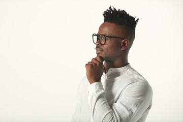 handsome young african man in glasses and white shirt on a white background