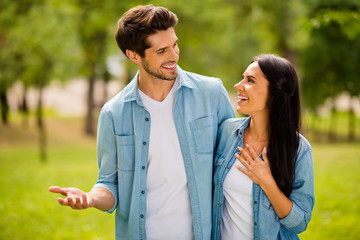 Obraz premium Photo of charming pair walking summer park speaking overjoyed wear denim outfit