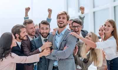 close up. cheerful company employees applauding their colleague.