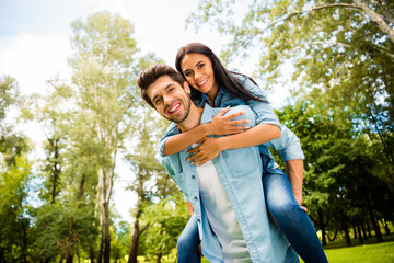 Low angle view photo of cute pair rejoicing together walking summer green park outdoors wear denim outfit