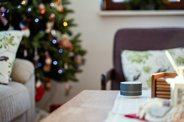 Smart ai speaker. Smart home concept with christmas tree in background