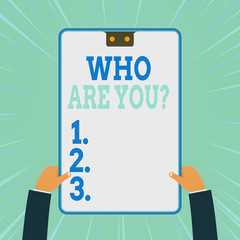 Conceptual hand writing showing Who Are You Question. Concept meaning asking about someone identity or demonstratingal information Two male hands holding electronic device geometrical background