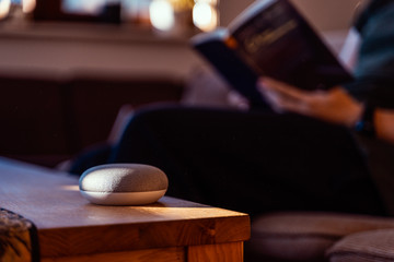 Smart ai speaker. Smart home concept with man reading in the background